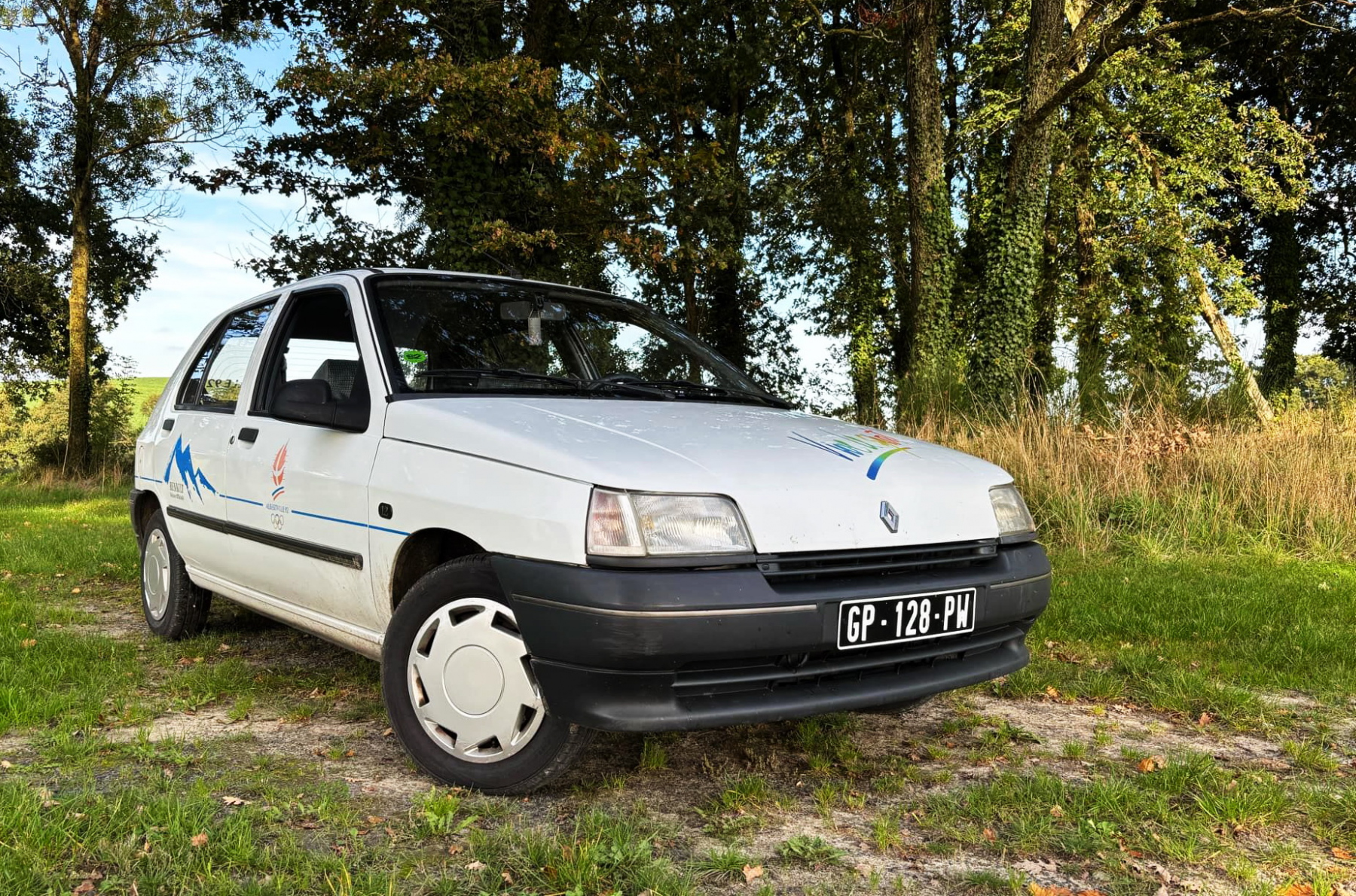 Illustration - Ne pas confondre avec la série limitée de Clio construite à 1800 exemplaire baptisée Olympique 92 lors de cet événement sportif. La Clio Olympique d 'Alex RT s'éloigne de cette série spéciale par son moteur Énergy 1,2 l 60 ch et un équipement différent. Néanmoins, elle adopte la même couleur blanche glacier 389. Les lecteurs de POA ont déjà pu découvrir la Twingo accessoirisée d'Alex il y a quelques mois. Aujourd'hui, il nous évoque sa rarissime pépite.